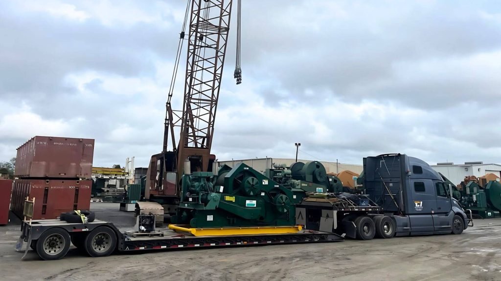 Crane loaded on a double drop trailer for construction machinery transport from New Orleans