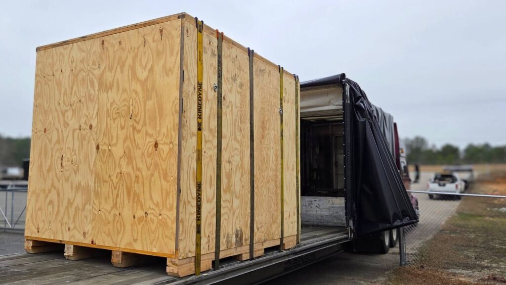Crated machine loaded onto an open Conestoga trailer in Los Angeles Crated machine loaded onto an open Conestoga trailer in Los Angeles