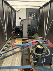 Inside a Conestoga trailer with freight strapped to the deck and the side tarps closed