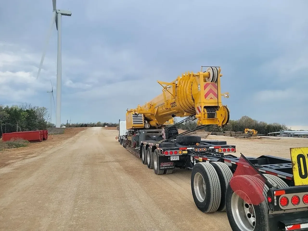 Yellow crane boom on a multi axle oversize trailer