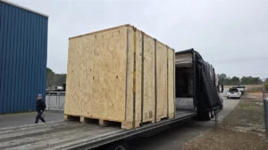 Large wood crate on a flatbed at a dock