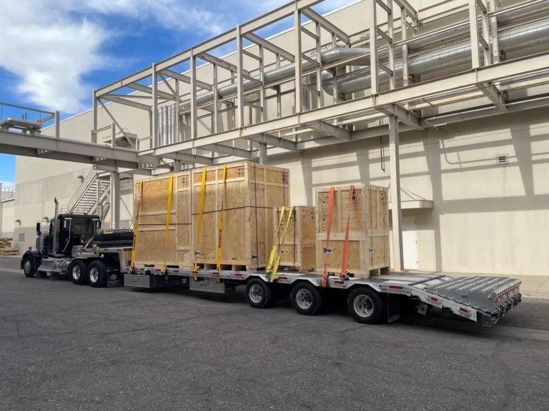 Wood machinery crates from more than one shipper sharing a step deck for a Los Angeles to Texas shared truckload