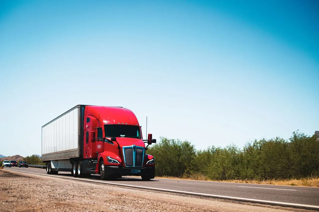 Dry van semi truck with a 53 foot trailer on the highway