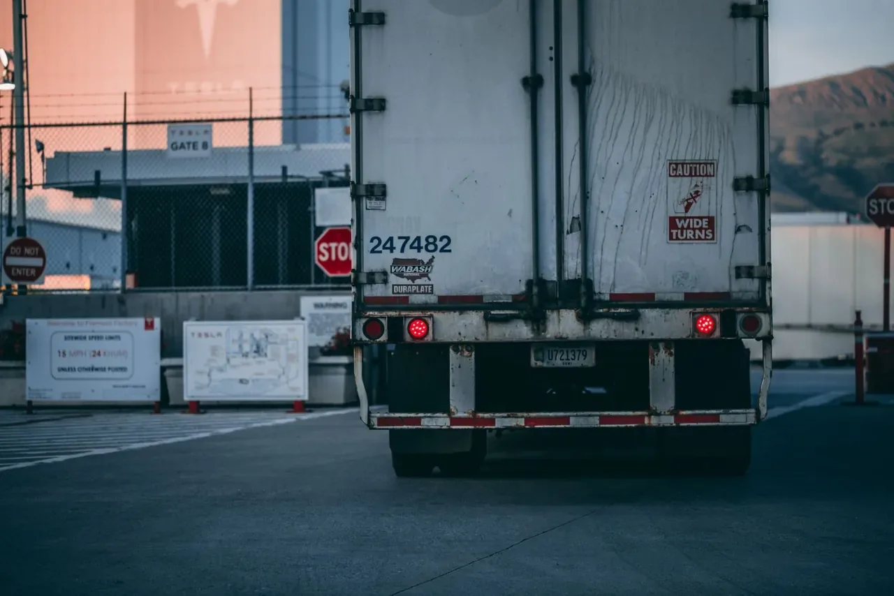 Dry van trailer rear doors open at a loading yard