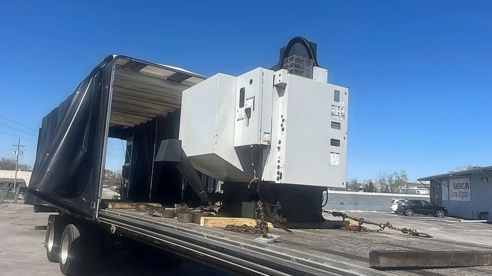 CNC Machine Chained on a Conestoga CNC machine chained on an open Conestoga deck for a partial truckload shipment