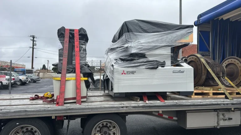 Wrapped EDM machine strapped on a flatbed trailer in California
