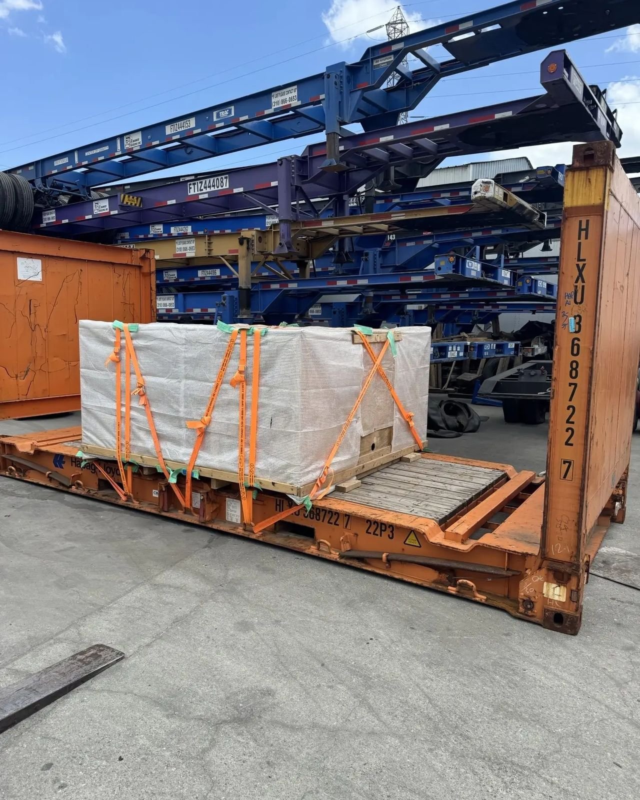 How to ship a crate on a flat rack container in Los Angeles, shrink wrapped and strapped down at a chassis yard