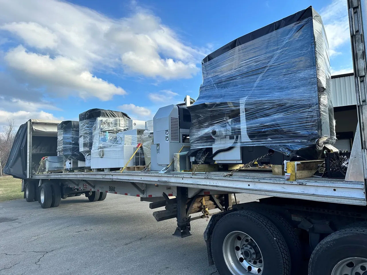 How to ship multiple shrink wrapped machines on one flatbed with a Conestoga tarp system from Los Angeles