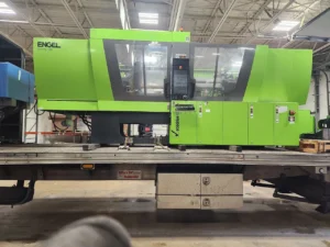 Injection molding machine on a flatbed, side view