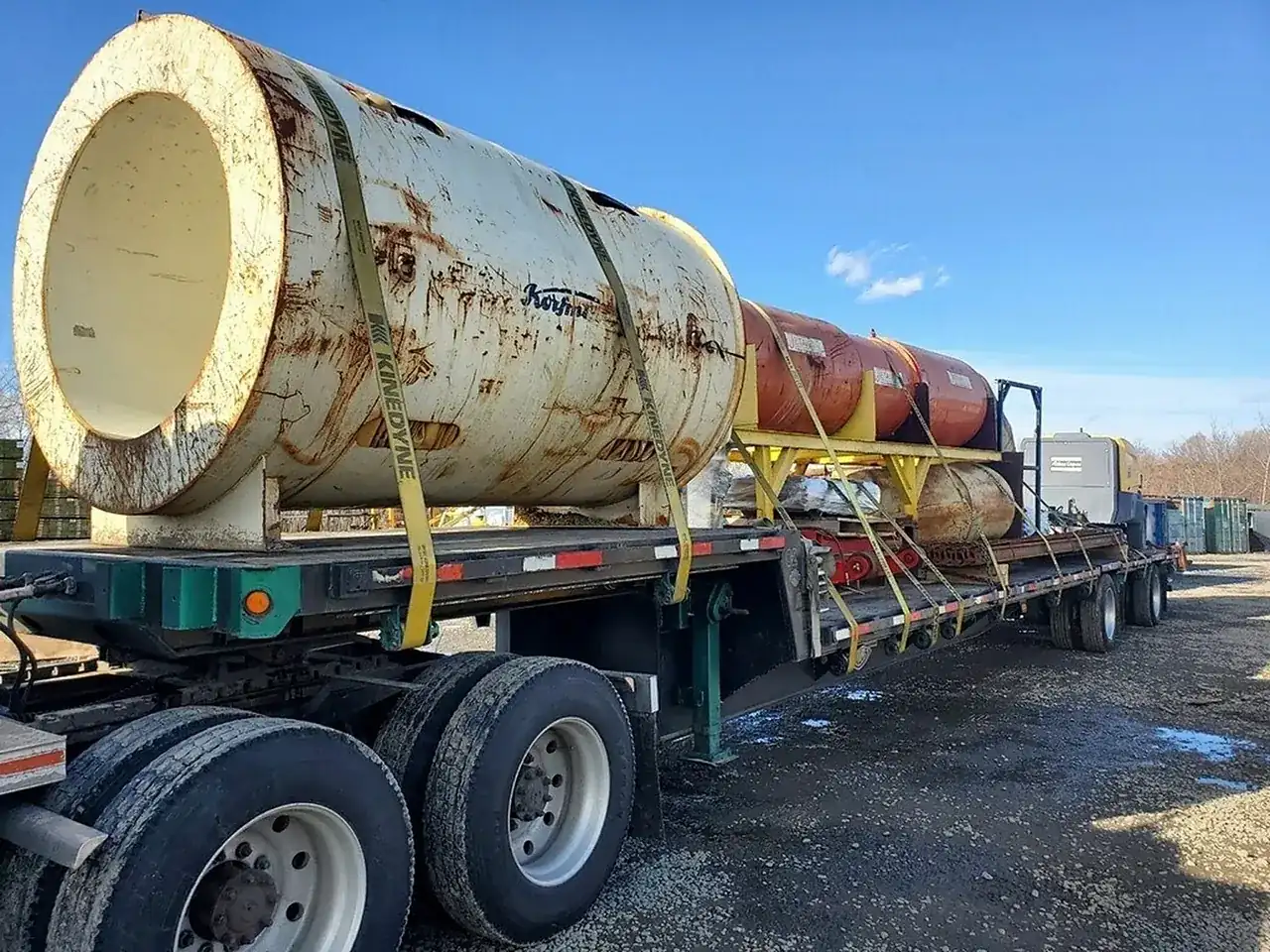 Large tank chained on a flatbed trailer