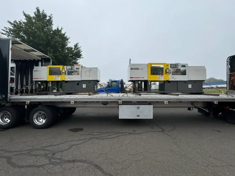 Injection molding machines loaded on a Conestoga flatbed trailer in Los Angeles