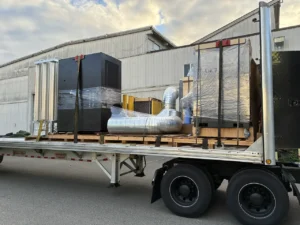 Wrapped equipment and ducting from several shippers sharing a flatbed for a Los Angeles PTL load