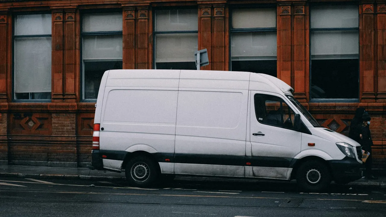 White high roof cargo van parked on a city street