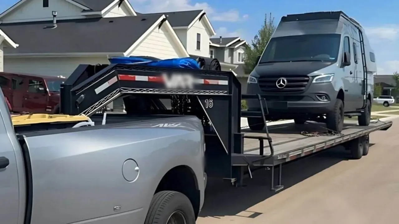 High-roof Sprinter van on a ramp-equipped step-deck trailer in Los Angeles
