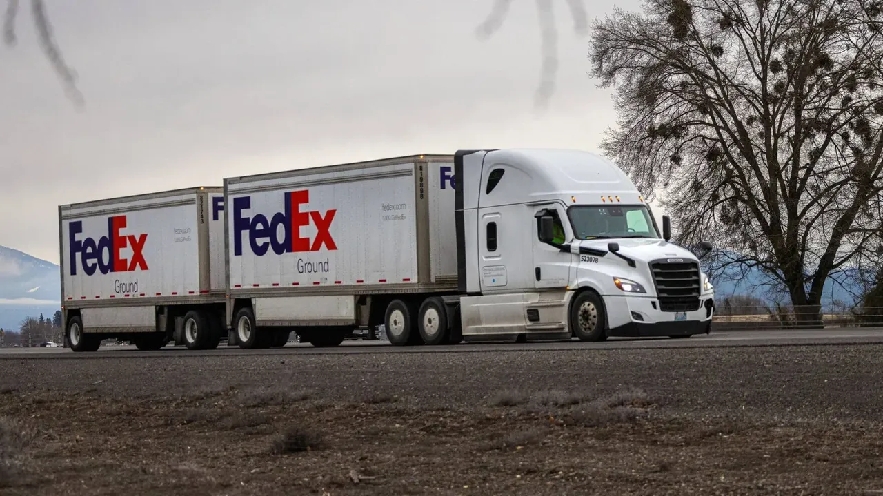 LTL Freight Truck on the Highway White FedEx semi-truck hauling double trailers along a highway